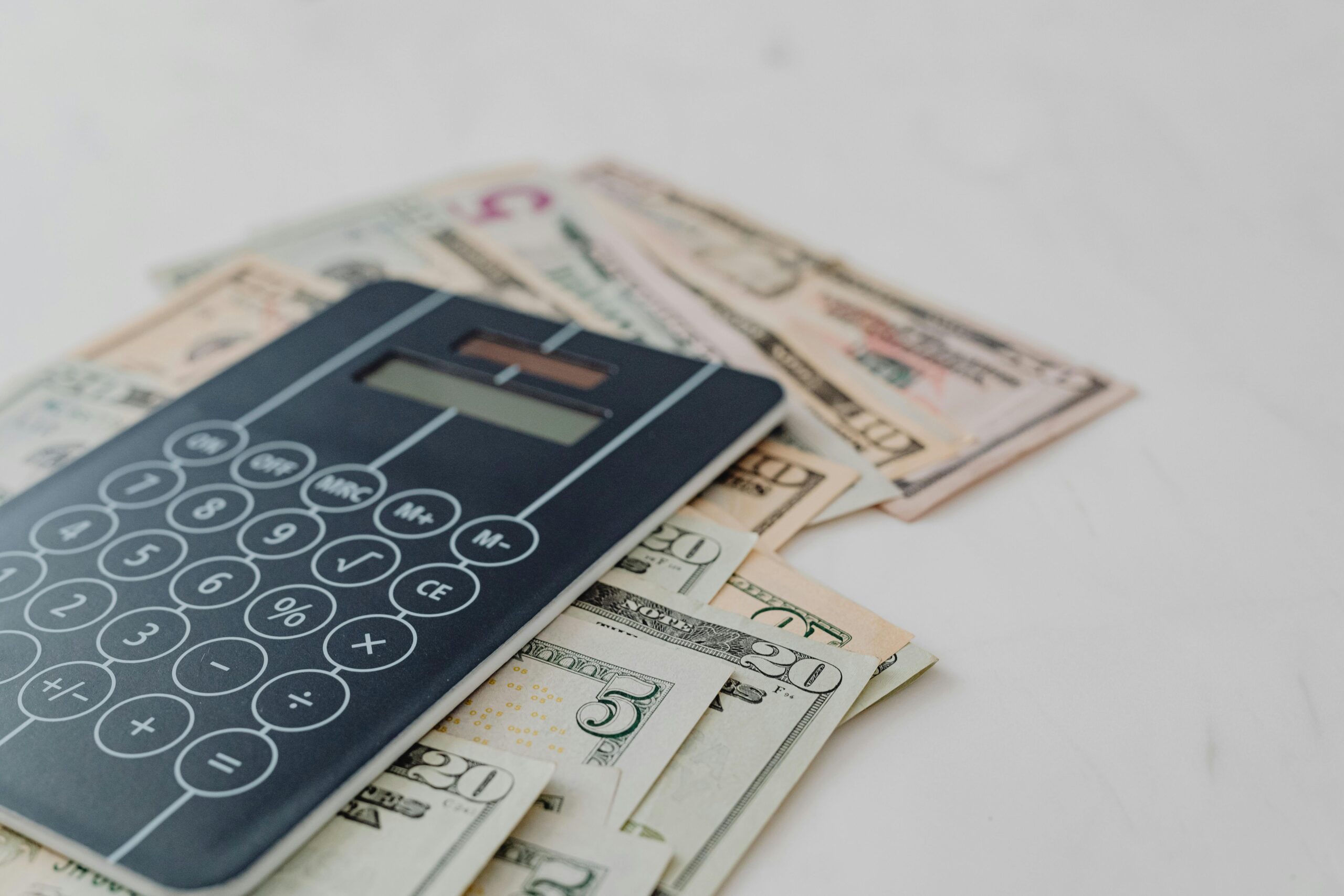 Calculator and cash symbolizing business valuation and sale preparation.